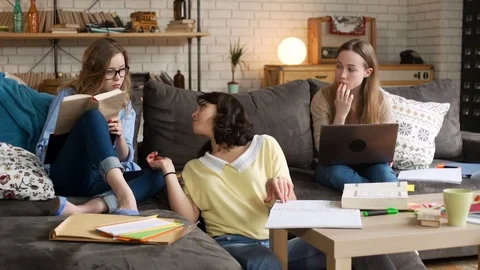 Three young female student study together being serious and concentrated Stock Footage 75963912