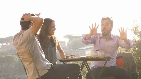 Three young friends having fun laughing telling stories and jokes with Stock Footage 90776688