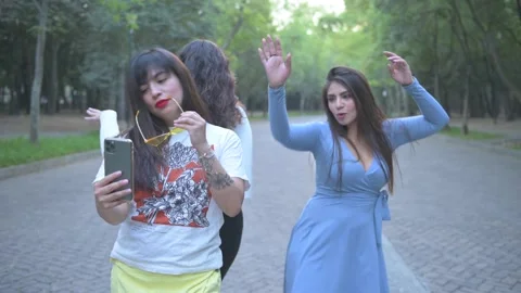Three young friends taking a selfie and smiling in the city, Stock Footage 154424323