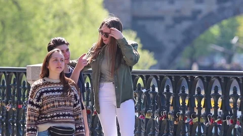 Three young friends walking on the bridge in Prague Stock Footage 110911499
