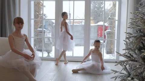 Three young girls are dancing in a living room Stock Footage 301625323