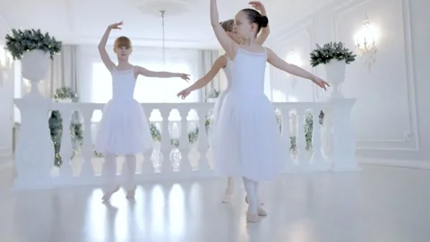 Three young girls are dancing in a white room Stock Footage 303945348
