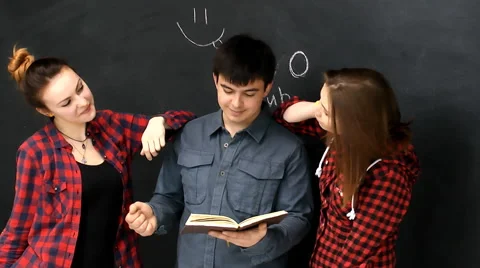 Three young guys  with books fun and easy communicate of the board background Stock Footage 63364932