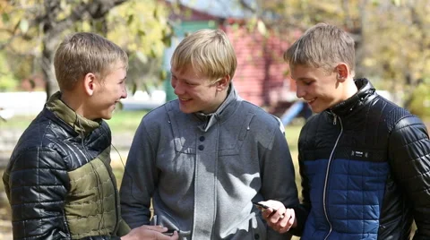 Three young guys on a friendly meeting in the park Stock Footage 43856900