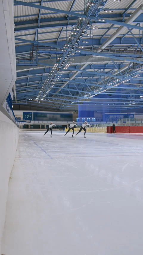 Three Young Ice Racers Running and Crossing Finish Line Stock Footage 252245651