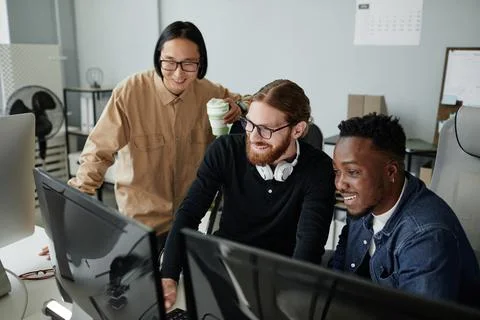 Three young intercultural diversity programmers decoding data Stock Photos