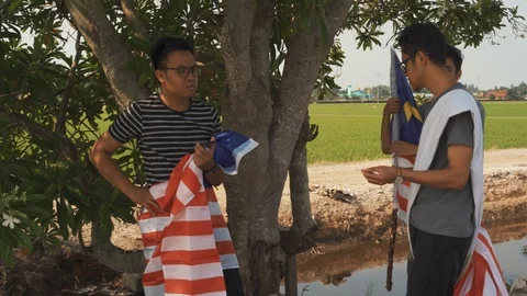 Three young man with Malaysian's flag or Jalur Gemilang. Independent Day Stock Footage 94011105