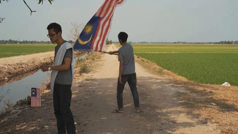 Three young man with Malaysian's flag or Jalur Gemilang. Independent Day Stock Footage 94011346