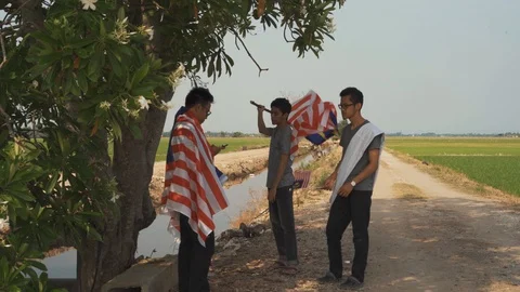 Three young man with Malaysian's flag or Jalur Gemilang. Independent Day Stock Footage 94011639