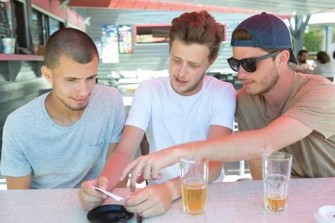Three young men in a bar Stock Photos