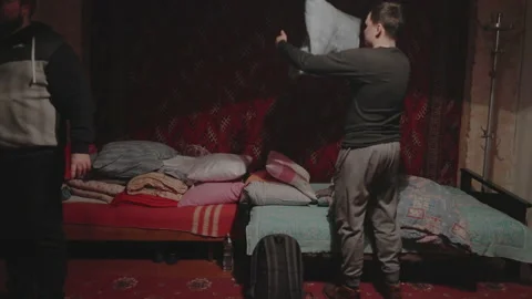 Three young men make a bed on their beds Video stock 231710444