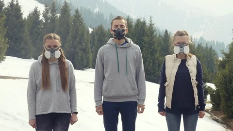 Three young men stand in gas masks bad air Video stock 112282776