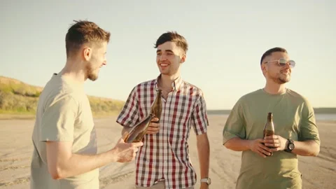 Three young men talking, laughter and drinks beer outdoors, embracing the joys Stock Footage 286077968