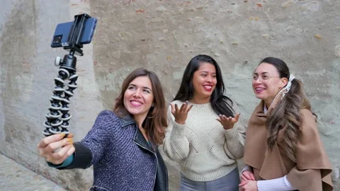 Three young multi ethnic women smiling and saying hello having a video call. Video stock 166300149