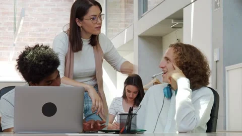 Three young multiethnic people work as a team in an office or a coworking Stock Footage 160217996