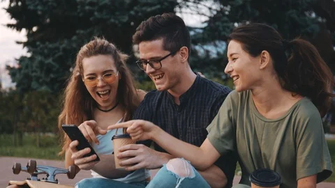 Three young multiracial people spending time together. Happy smiling students Video stock 129679861