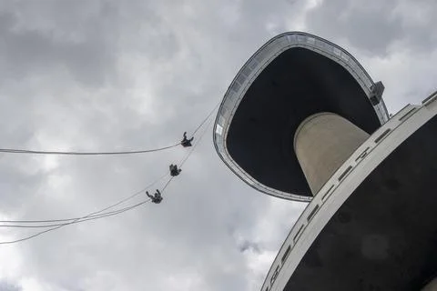 Three young People abseiling down the Eromast tower in Rotterdam Stock Photos