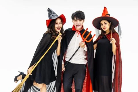 Three young people dressed in different costumes for Halloween isolated on white Stock Photos