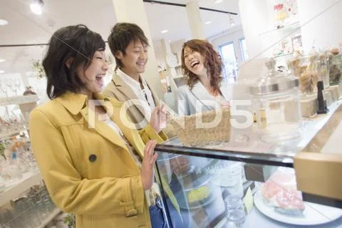Three young people in the shop Stock Photos