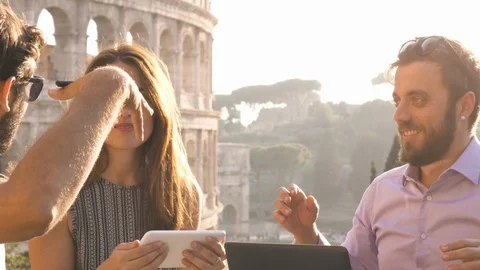 Three young people working together on a project with laptop and tablet Stock Footage 85602421