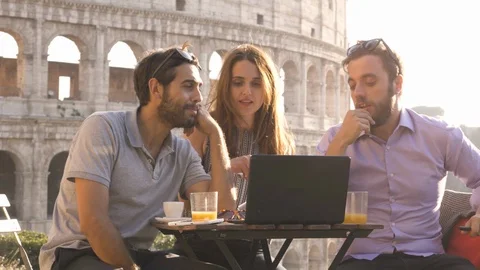 Three young people working together on a project with laptop and tablet Stock Footage 85797496