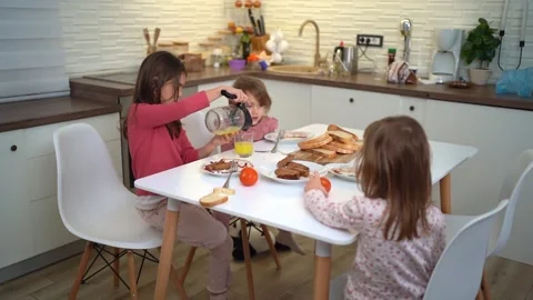 Three young sisters eating a healthy breakfast together Stock Footage 321944167