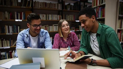Three young students study in the school library. Stock Footage 110933922