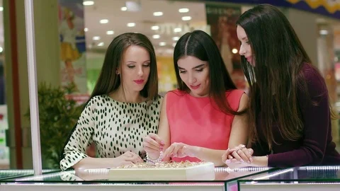 Three young women choosing a suitable ring to one of them Stock-Footage 72691014