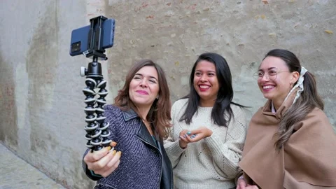 Three young women smiling and saying hello having a video call. Stock Footage 166300666
