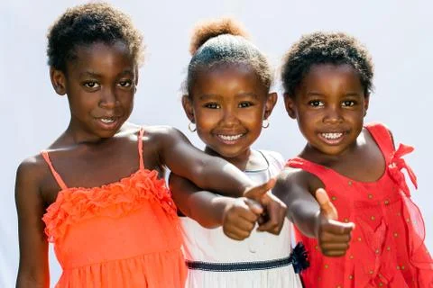 Threesome african girls doing thumbs up together. Stock Photos