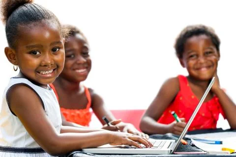 Threesome african kids with laptop at table. Stock Photos