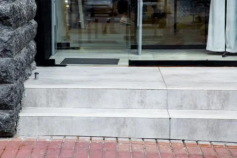 Threshold from light gray ceramic tile with step at entrance to store. Stock Photos