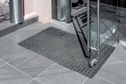 Threshold made of gray ceramic stone tile at entrance to store. Stock Photos