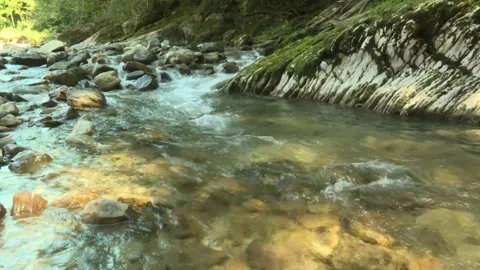 Threshold in a rocky mountain river, clear water breaks through the stones Stock Footage 170897857