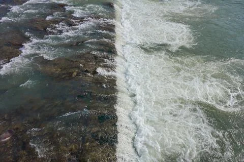 The threshold of a waterfall on a mountain river. Stock Photos