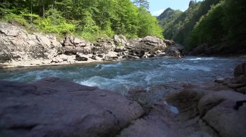 Thresholds of the beautiful mountain river against the wood Video stock 55525265
