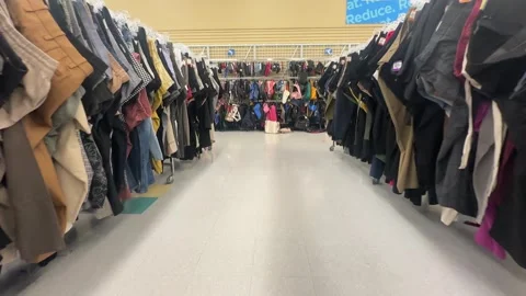 Thrift store clothes displayed gimbal walk trough Stock Footage 345966915