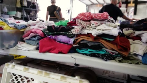 Thrifting clothes on a table 動画素材 268136794