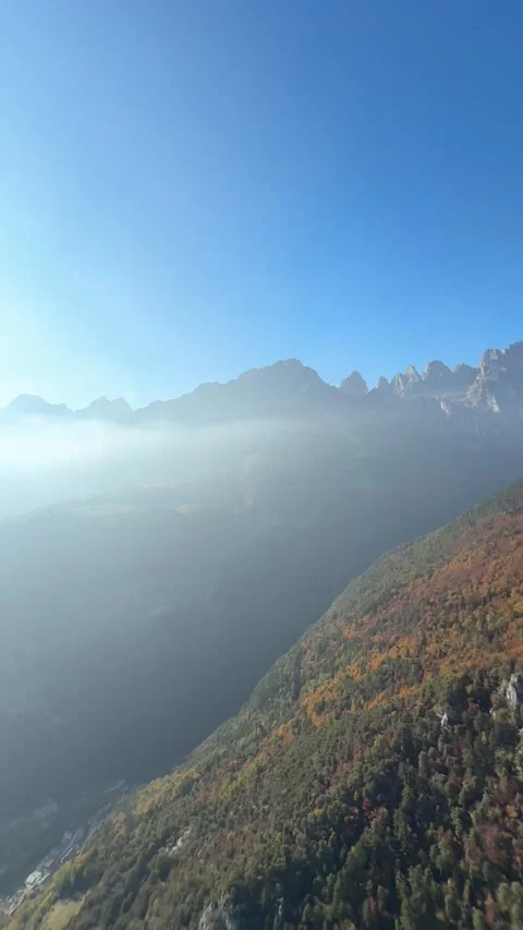 A Thrill-seeker Soars High Above Forested Cliffs and Rugged Mountains While 库存影片 334643220