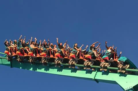 Thrill Seekers Enjoy a Roller Coaster Ride Stock Photos
