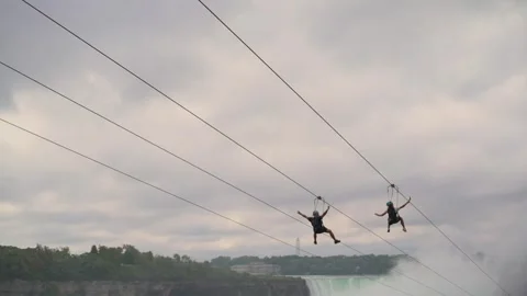 Thrill-seekers enjoy a ziplining experience above Niagara Falls, surrounded by Vídeo Stock 290793705
