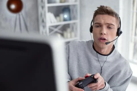 Thrilled young man playing computer games Foto stock