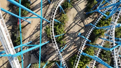 A thrilling aerial shot of a roller coaster in an amusement park Stock Footage 294261790