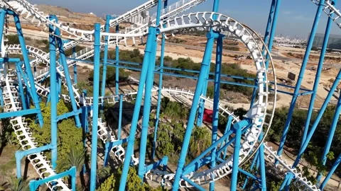 A thrilling aerial shot of a roller coaster in an amusement park Stock Footage 294261908