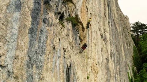 The Thrilling Ascent: A Man Conquering the Vertical Challenge with Courage and Stock Footage 257230852