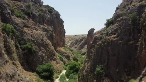 Thrilling drone flight through a very narrow and winding rock gorge. Stock Footage 155191139