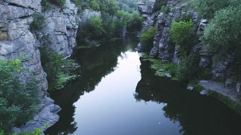 Thrilling mountain creek flowing between high rocks in the Carpathians in summer Video stock 99736909