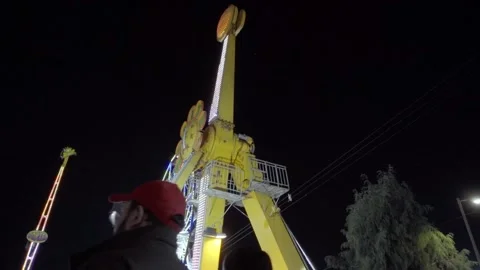 Thrilling pendulum ride at Cholula Puebla Festival Mexico in slow motion Stock Footage 334053494