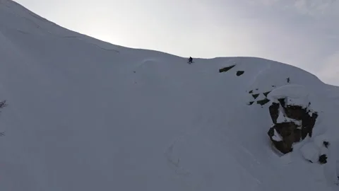 Thrilling skiing adventure down steep snowy mountain cliff Stock Footage 309967064