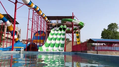 Thrilling water recreation facility featuring spiral slides splash pool and Stock Footage 337541135